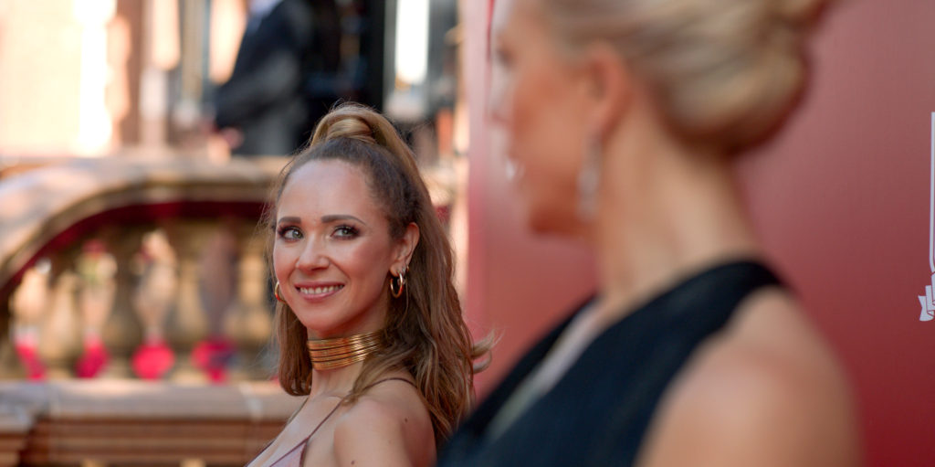 Photo from Ted Lasso, with Keeley and Rebecca smiling at each other