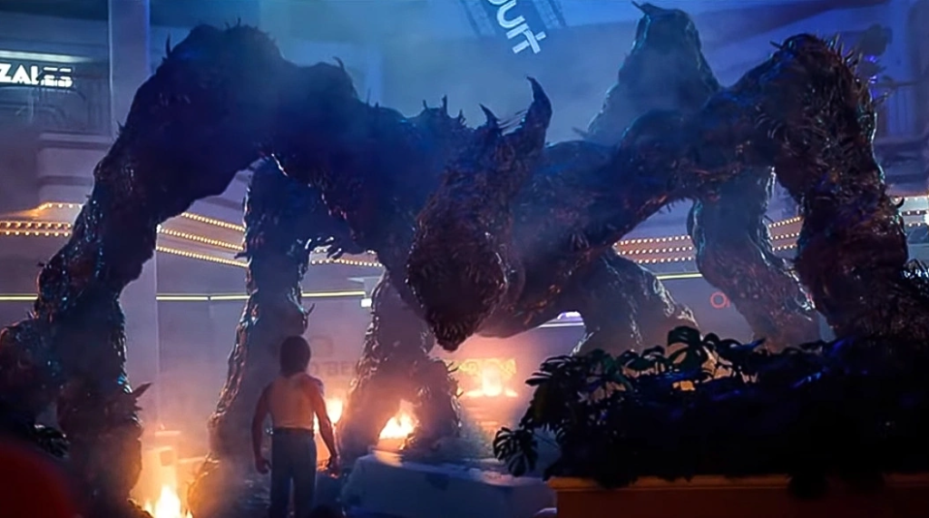 Giant goo monster in a mall, staring down at Billy Hargrove, played by Dacre Montgomery.